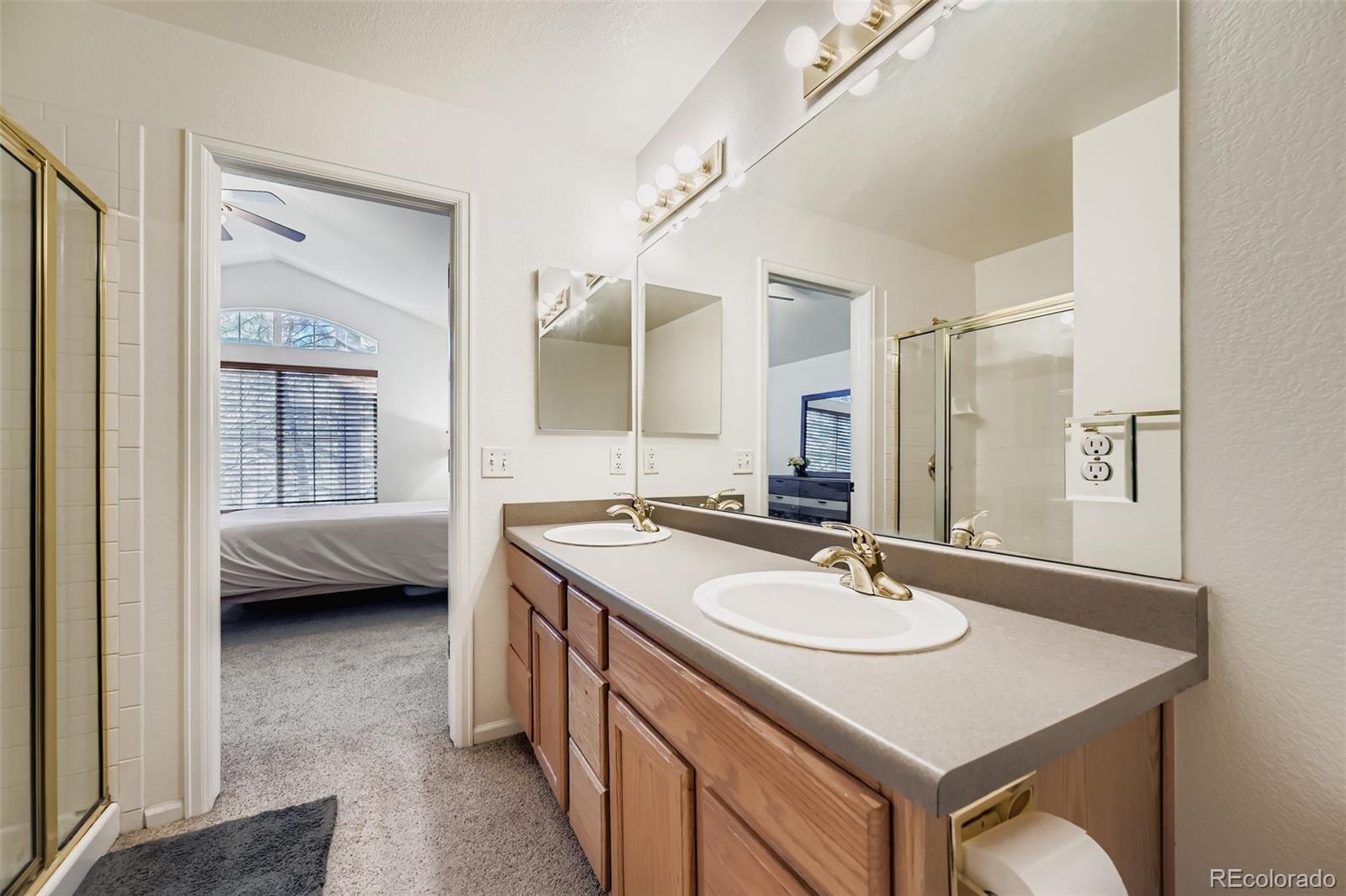 208 Remuda Lane Lafayette, CO 80026 - Photo 20 of 28 a en suite bathroom with a sink double vanity and a mirror