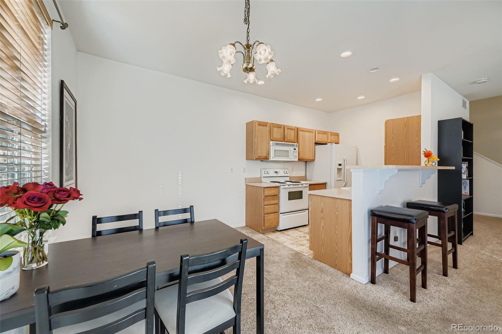 208 Remuda Lane Lafayette, CO 80026 - Photo 10 of 28 a view of a dining room with furniture and a chandelier