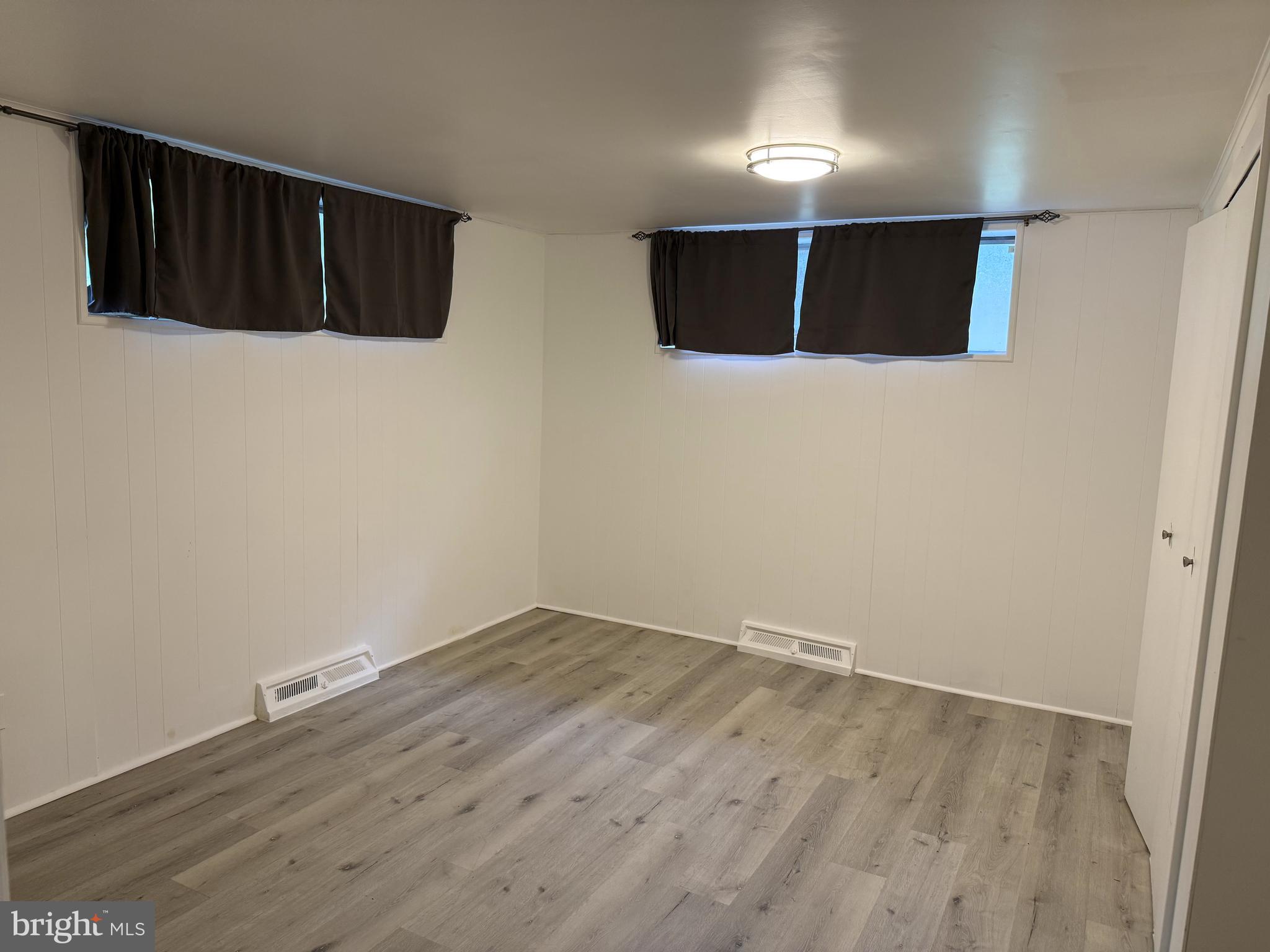 3207 Midfield Road Pikesville, MD 21208 - Photo 36 of 45 a view of an empty room with wooden floor and a window