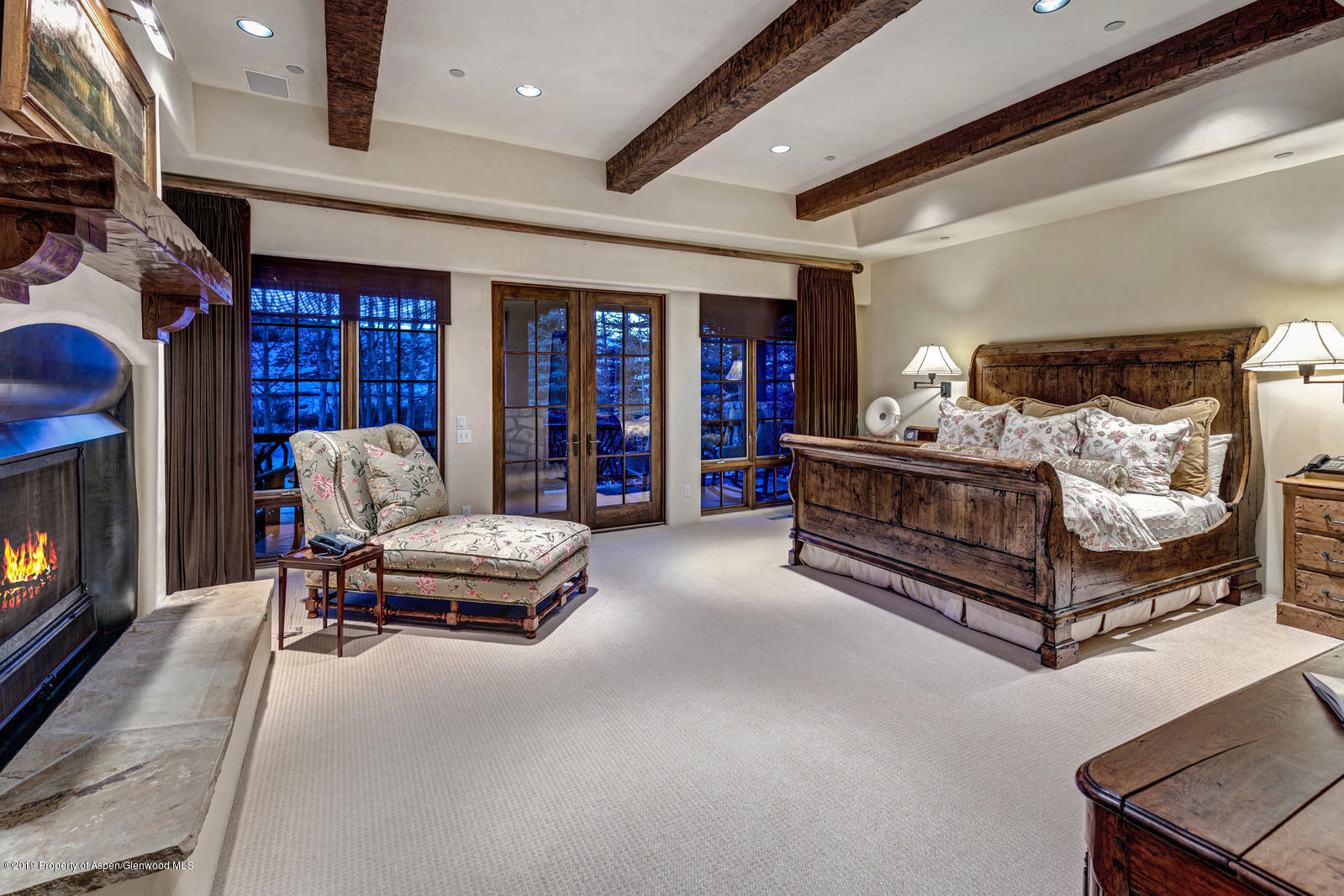 124 Cold Stream Lane Aspen, CO 81611 - Photo 22 of 38 a bedroom with furniture and a fireplace