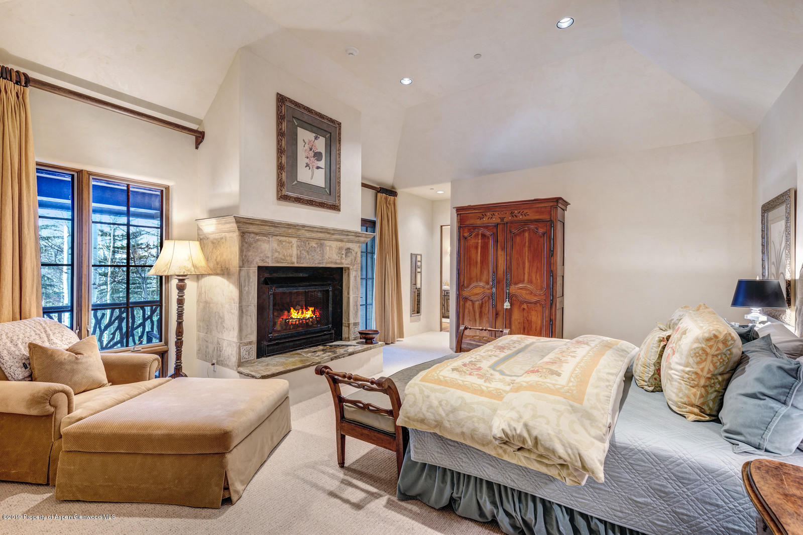 124 Cold Stream Lane Aspen, CO 81611 - Photo 28 of 38 a bedroom with a bed and a fireplace