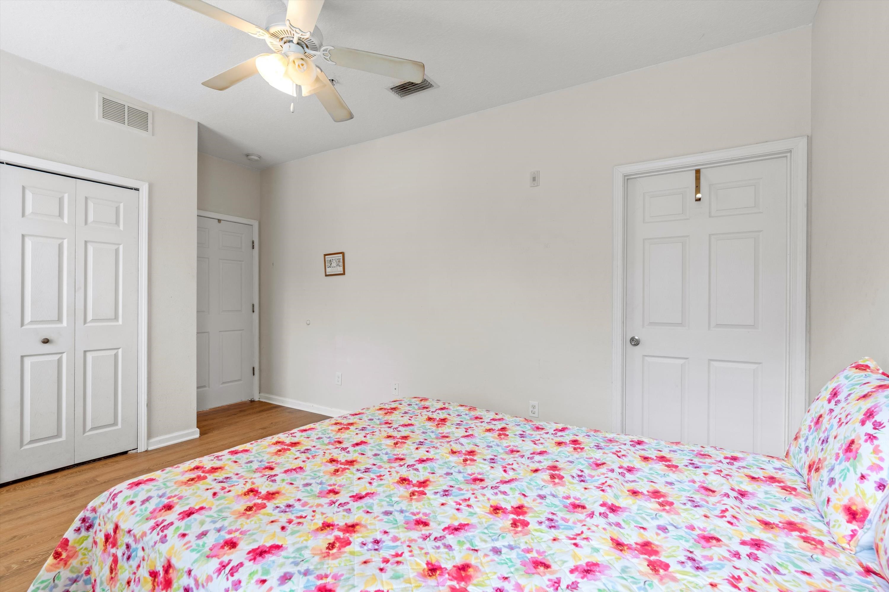 2330 Golden Lake Loop St. Augustine, FL 32084 - Photo 12 of 23 a bedroom with a bed and a chandelier