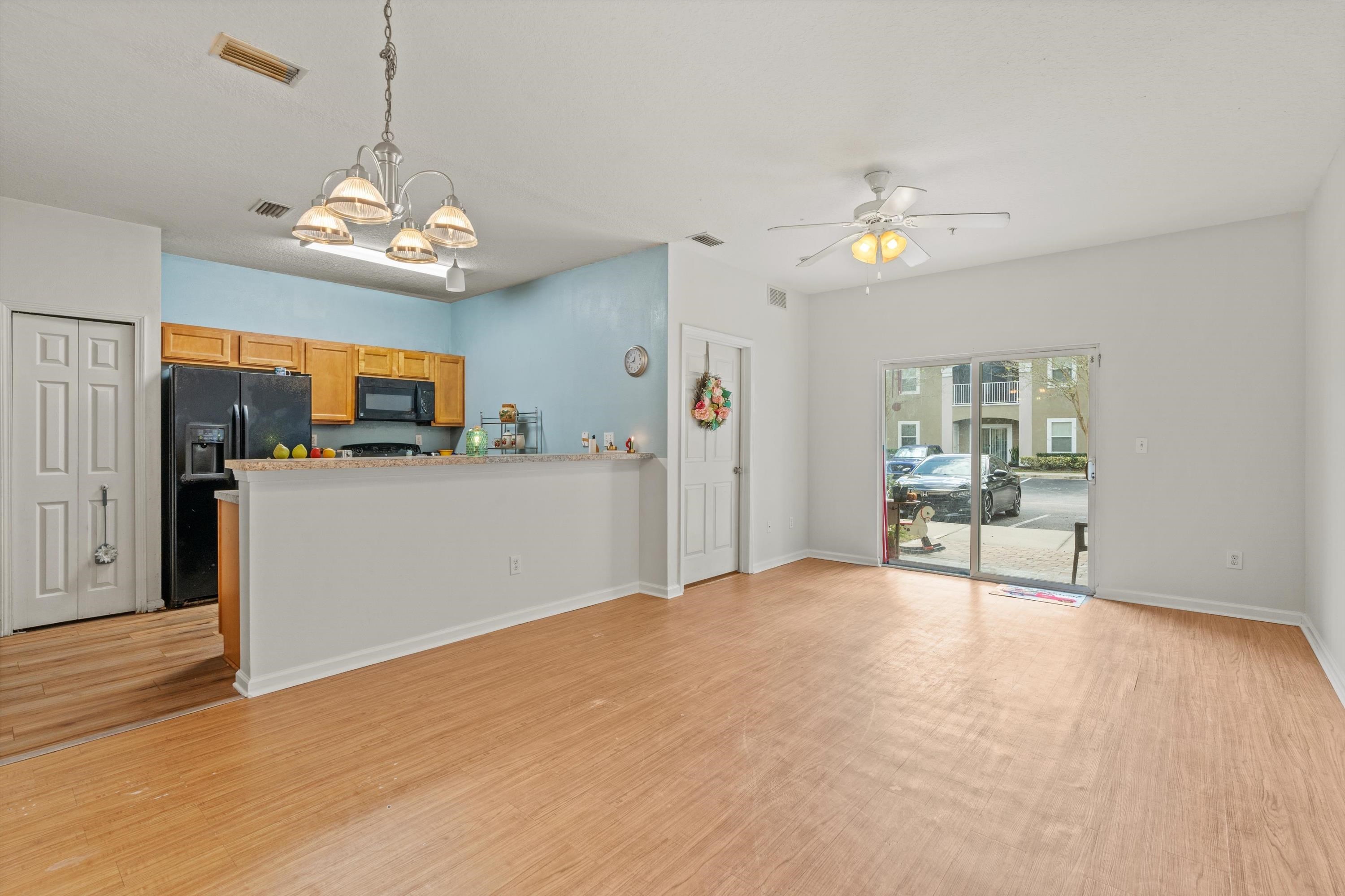 2330 Golden Lake Loop St. Augustine, FL 32084 - Photo 3 of 23 a view of a kitchen with a stove cabinets and wooden floor