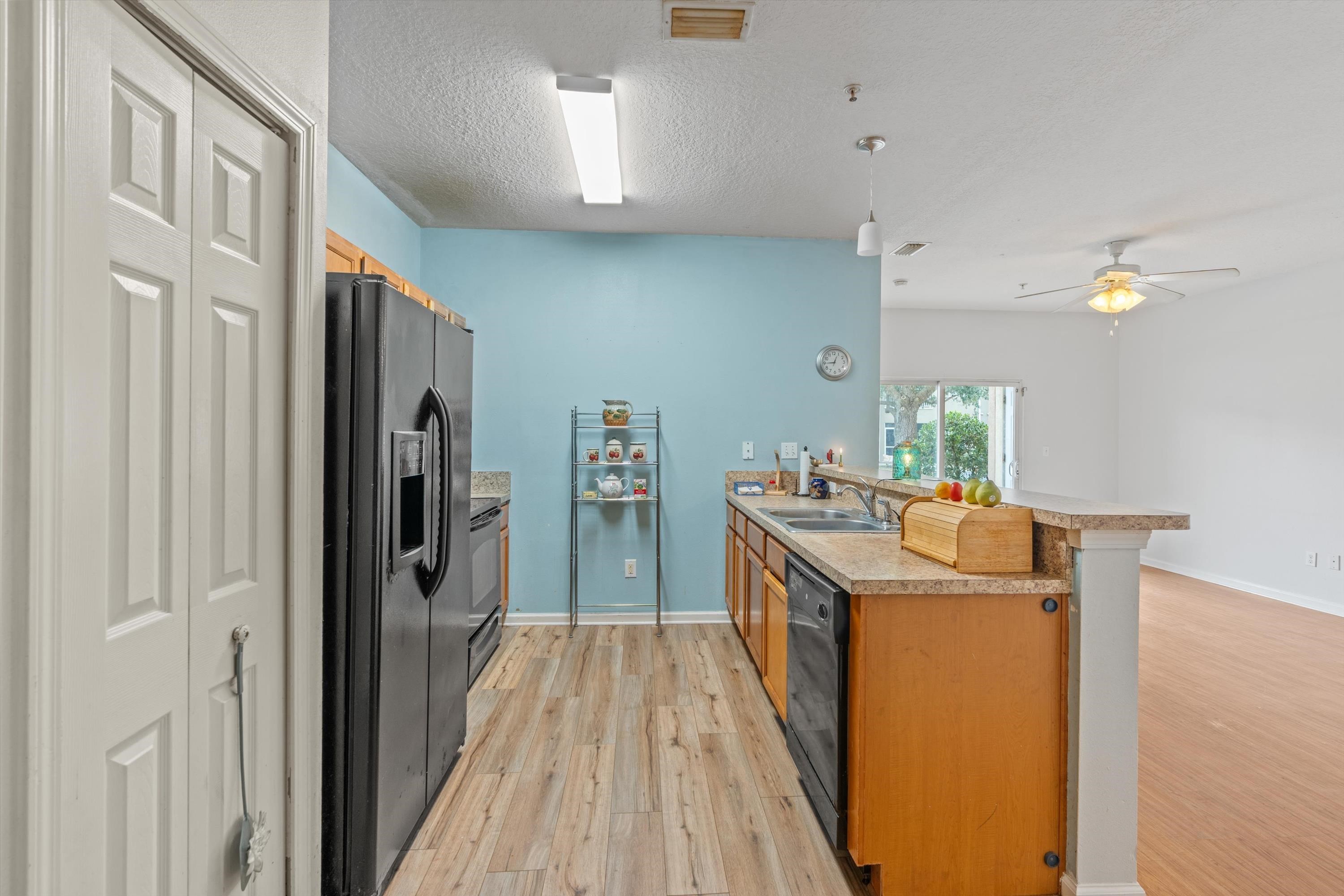 2330 Golden Lake Loop St. Augustine, FL 32084 - Photo 7 of 23 a kitchen with kitchen island wooden floor center island and stainless steel appliances