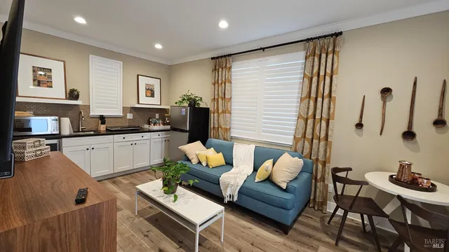 a living room with furniture and kitchen view