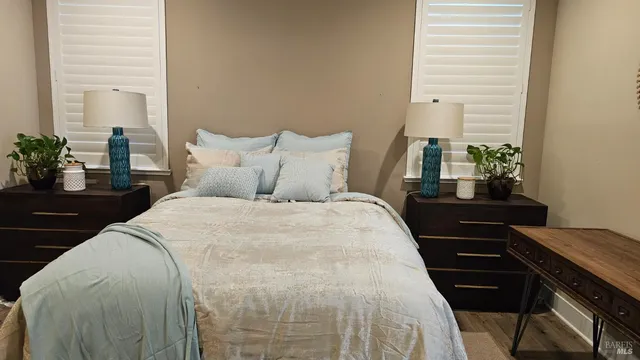 a bed sitting in a bedroom next to a window