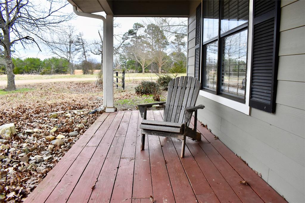 509 County Road 35985 Powderly, TX 75473 - Photo 11 of 37 a view of balcony with wooden floor and outdoor seating