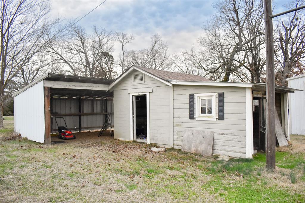 509 County Road 35985 Powderly, TX 75473 - Photo 17 of 37 a view of a house with a yard and garage