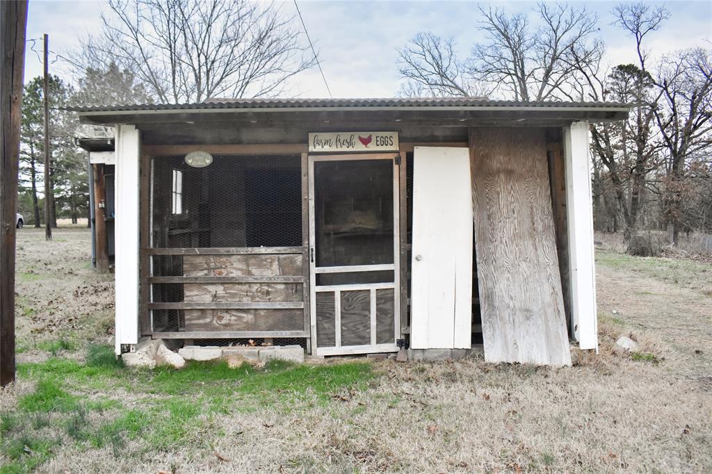 509 County Road 35985 Powderly, TX 75473 - Photo 21 of 37 a view of a house with a large window and wooden fence