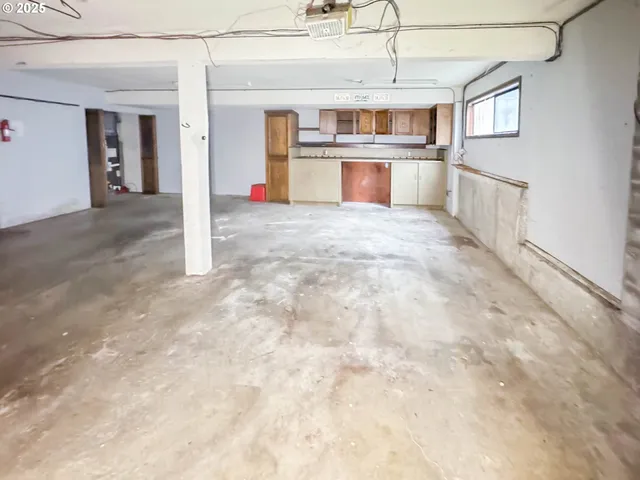a kitchen with stainless steel appliances cabinets and a window