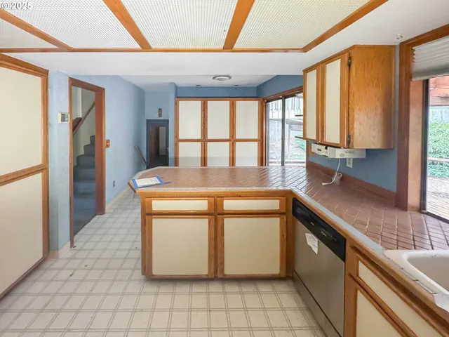 a kitchen with stainless steel appliances granite countertop a sink and a refrigerator