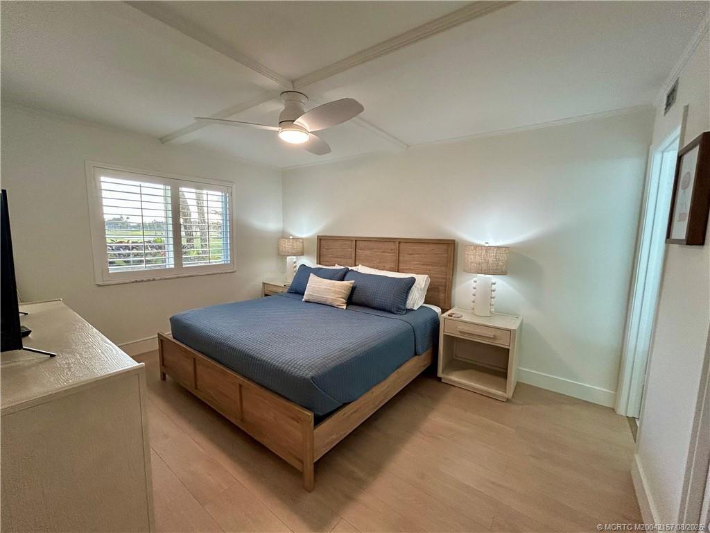 484 Northeast Plantation Road, Unit 4102 Stuart, FL 34996 - Photo 13 of 35 a bed sitting in a bedroom next to a window