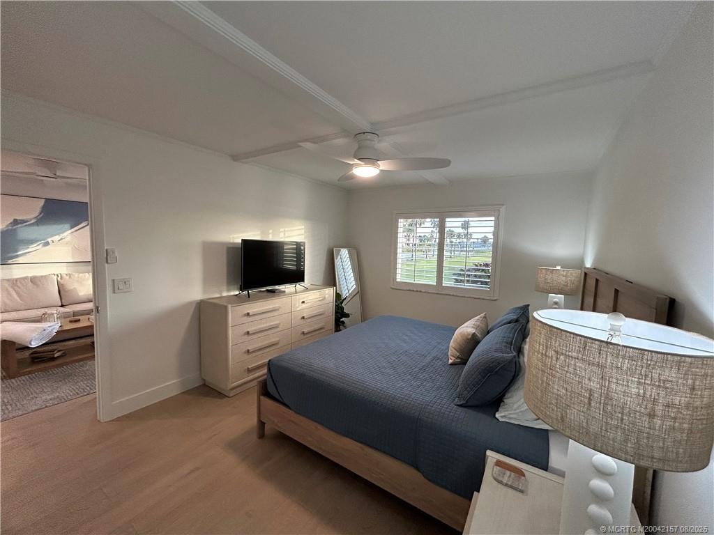 484 Northeast Plantation Road, Unit 4102 Stuart, FL 34996 - Photo 14 of 35 a bedroom with a bed and a couch