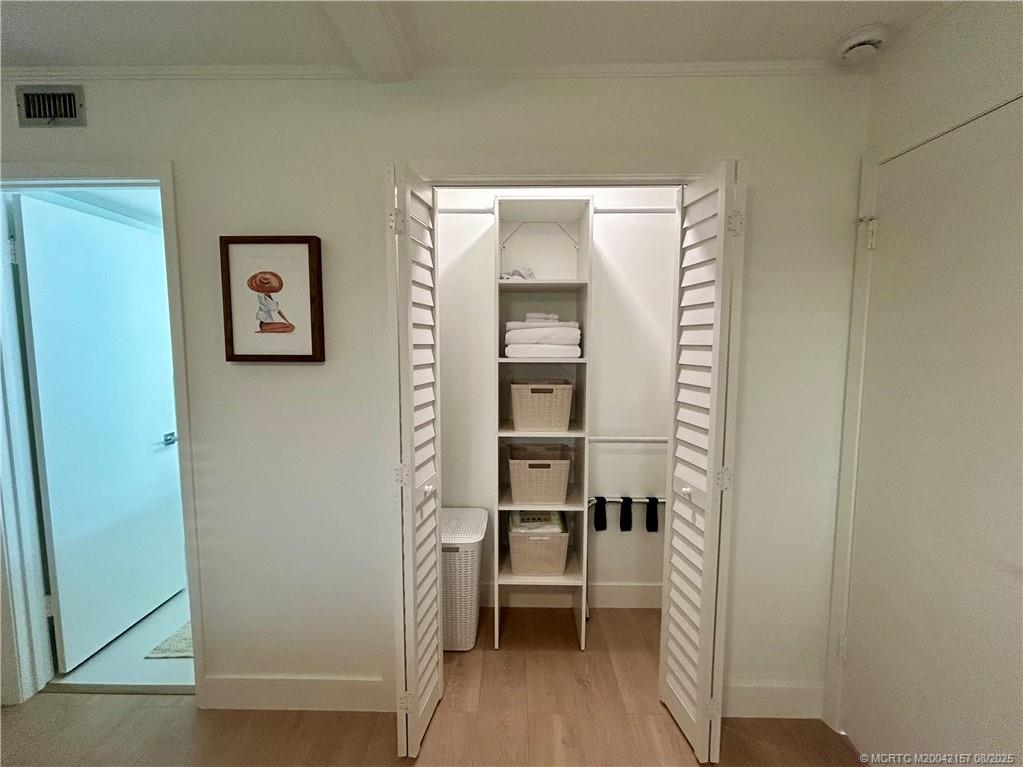 484 Northeast Plantation Road, Unit 4102 Stuart, FL 34996 - Photo 15 of 35 a view of a hallway with wooden floor and furniture