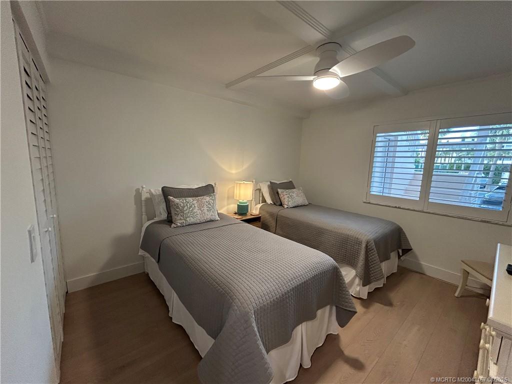 484 Northeast Plantation Road, Unit 4102 Stuart, FL 34996 - Photo 18 of 35 a bedroom with two beds and a window