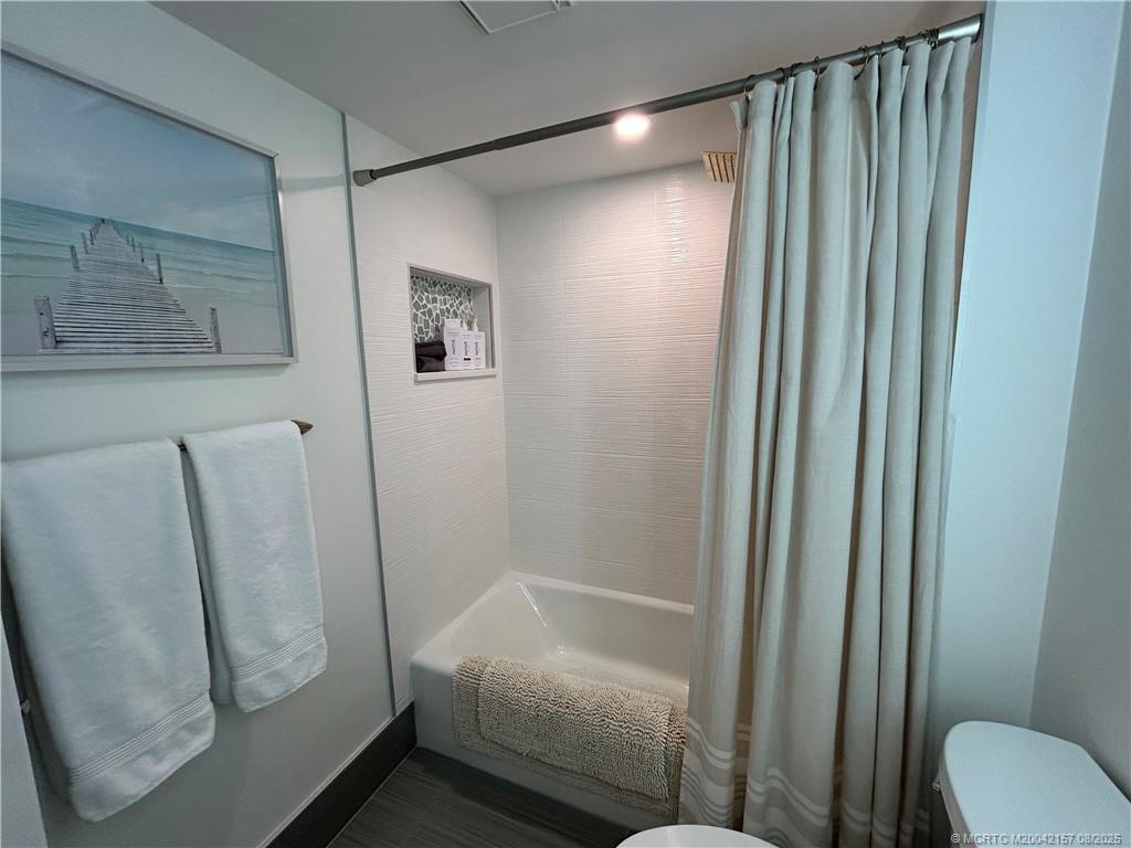 484 Northeast Plantation Road, Unit 4102 Stuart, FL 34996 - Photo 20 of 35 a bathroom with a shower and a toilet