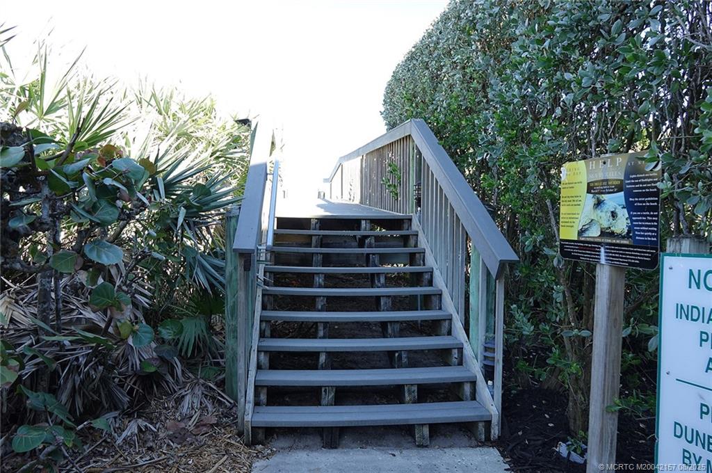 484 Northeast Plantation Road, Unit 4102 Stuart, FL 34996 - Photo 27 of 35 a view of a house with backyard and wooden fence