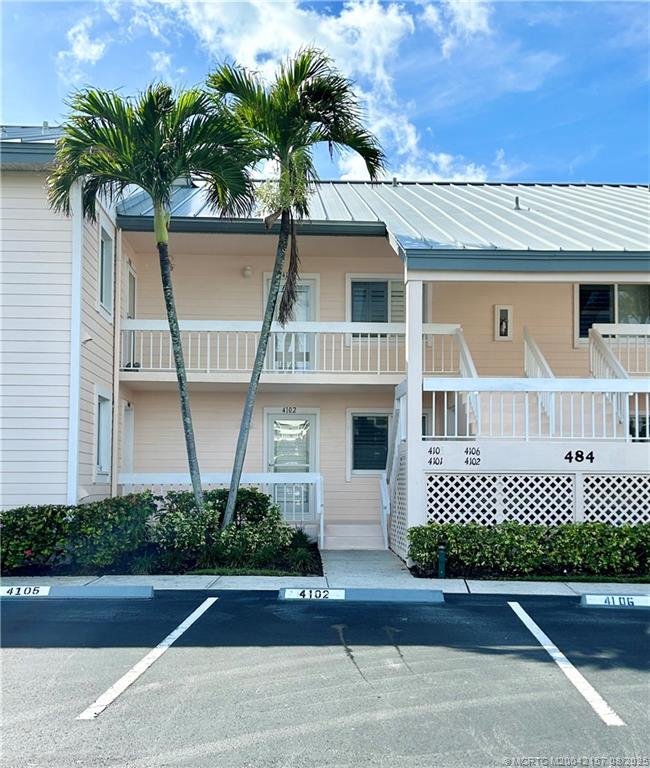 484 Northeast Plantation Road, Unit 4102 Stuart, FL 34996 - Photo 33 of 35 a front view of a house with a yard and garage