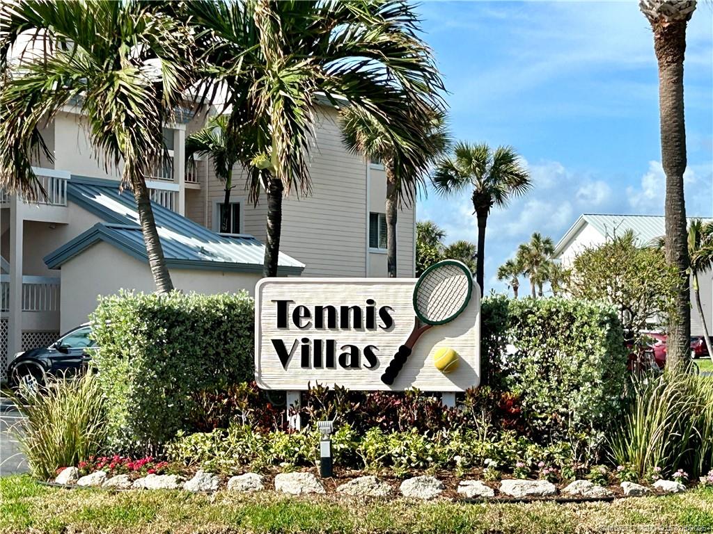 484 Northeast Plantation Road, Unit 4102 Stuart, FL 34996 - Photo 34 of 35 a sign that is sitting in front of flowers