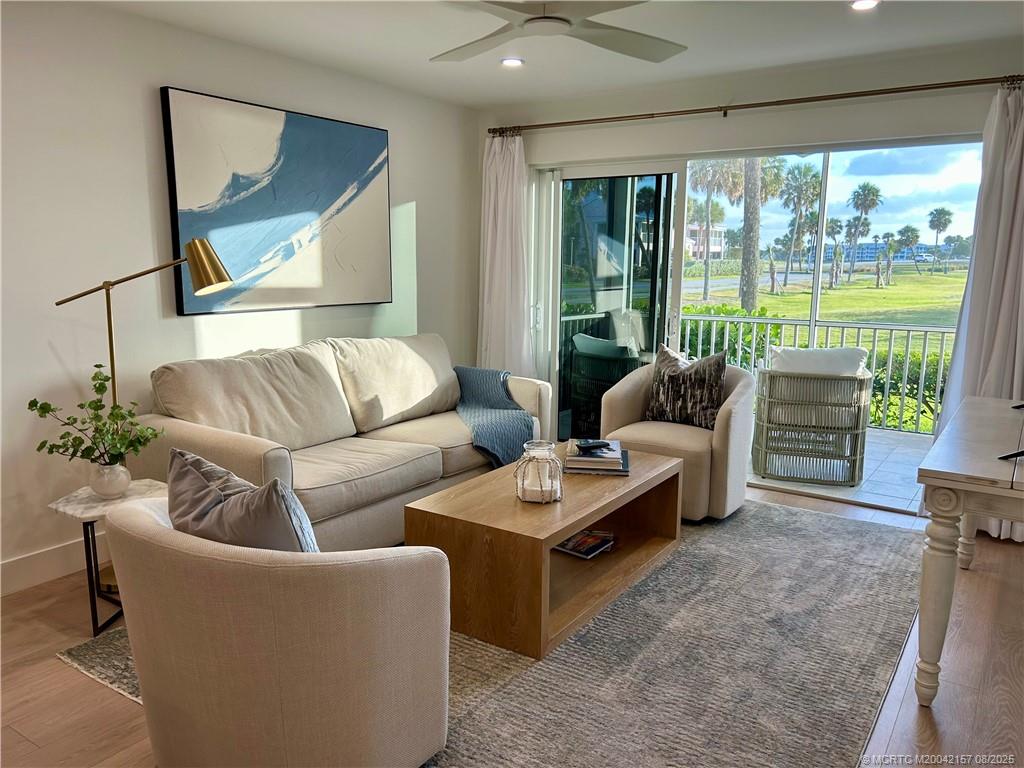 484 Northeast Plantation Road, Unit 4102 Stuart, FL 34996 - Photo 4 of 35 a living room with furniture and a large window