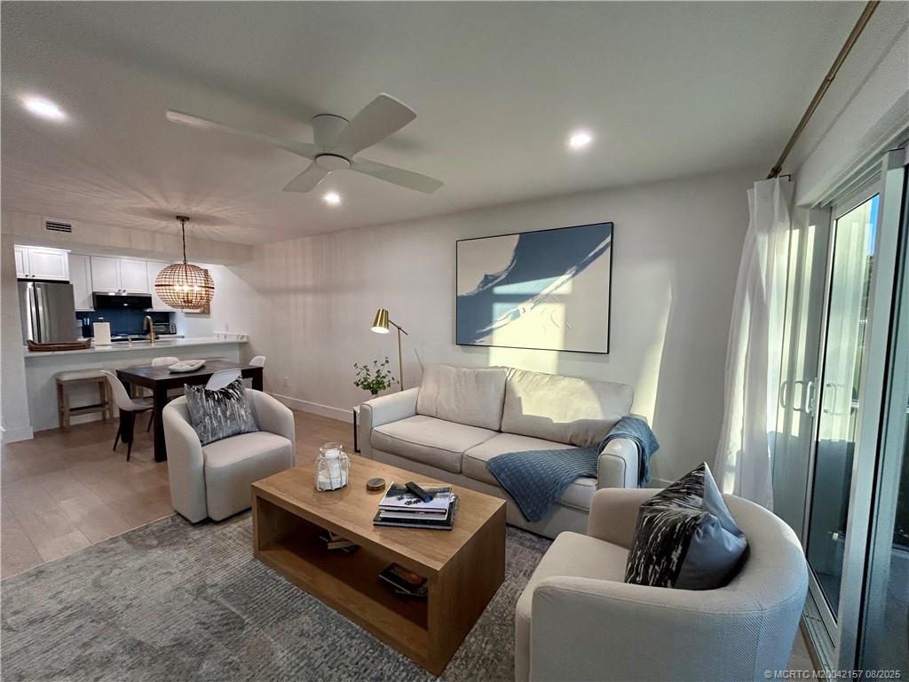 484 Northeast Plantation Road, Unit 4102 Stuart, FL 34996 - Photo 7 of 35 a living room with furniture and a large window