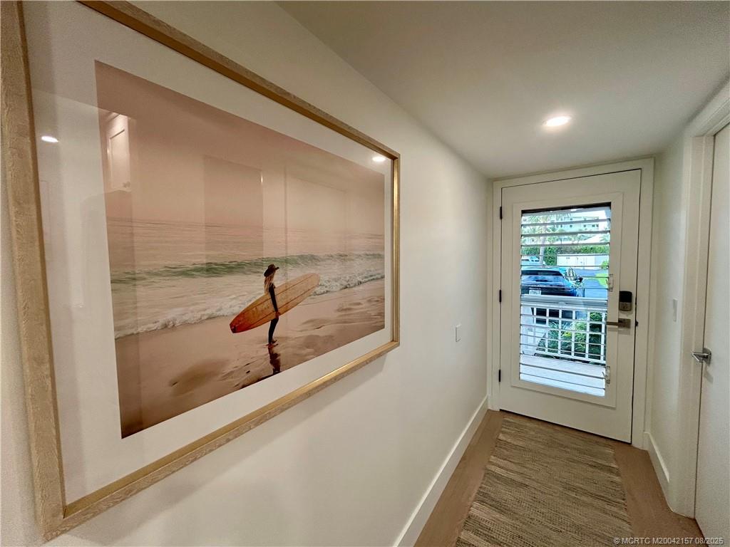 484 Northeast Plantation Road, Unit 4102 Stuart, FL 34996 - Photo 8 of 35 a view of a hallway with windows