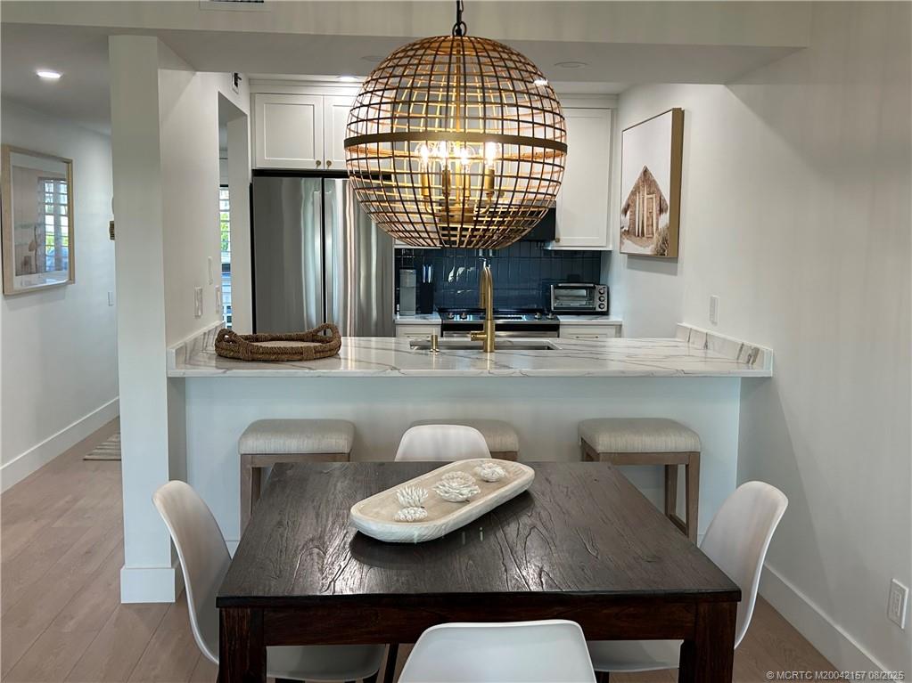 484 Northeast Plantation Road, Unit 4102 Stuart, FL 34996 - Photo 10 of 35 a dining room with furniture and window