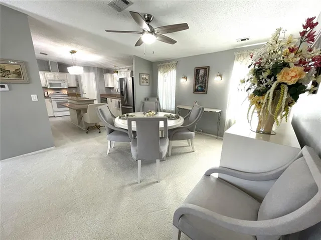 a view of a dining room with furniture and chandelier