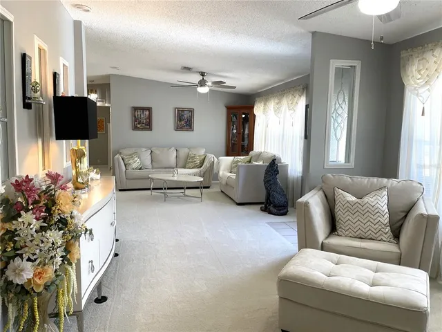 a kitchen with stainless steel appliances granite countertop a refrigerator a stove a sink dishwasher a dining table and chairs with wooden floor