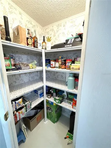 a bedroom with a bed couch and window