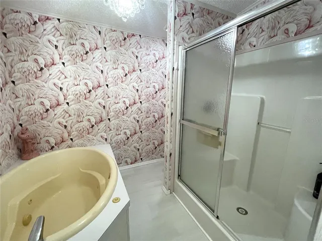 a bedroom with a bed and a large mirror