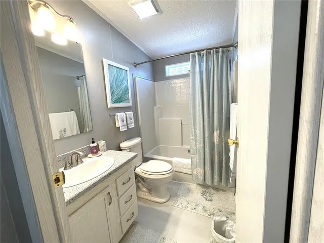 a view of a dining room with furniture and a chandelier