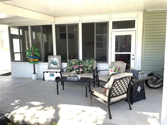 a view of a swimming pool with an outdoor space and seating area