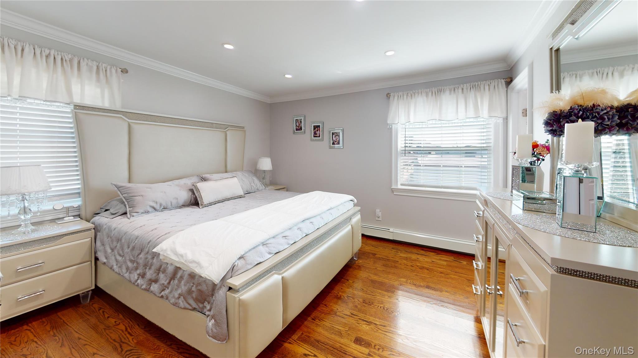 125 Spruce Street Lindenhurst, NY 11757 - Photo 12 of 29 Bedroom featuring crown molding, light wood-style flooring, a baseboard heating unit, and recessed lighting