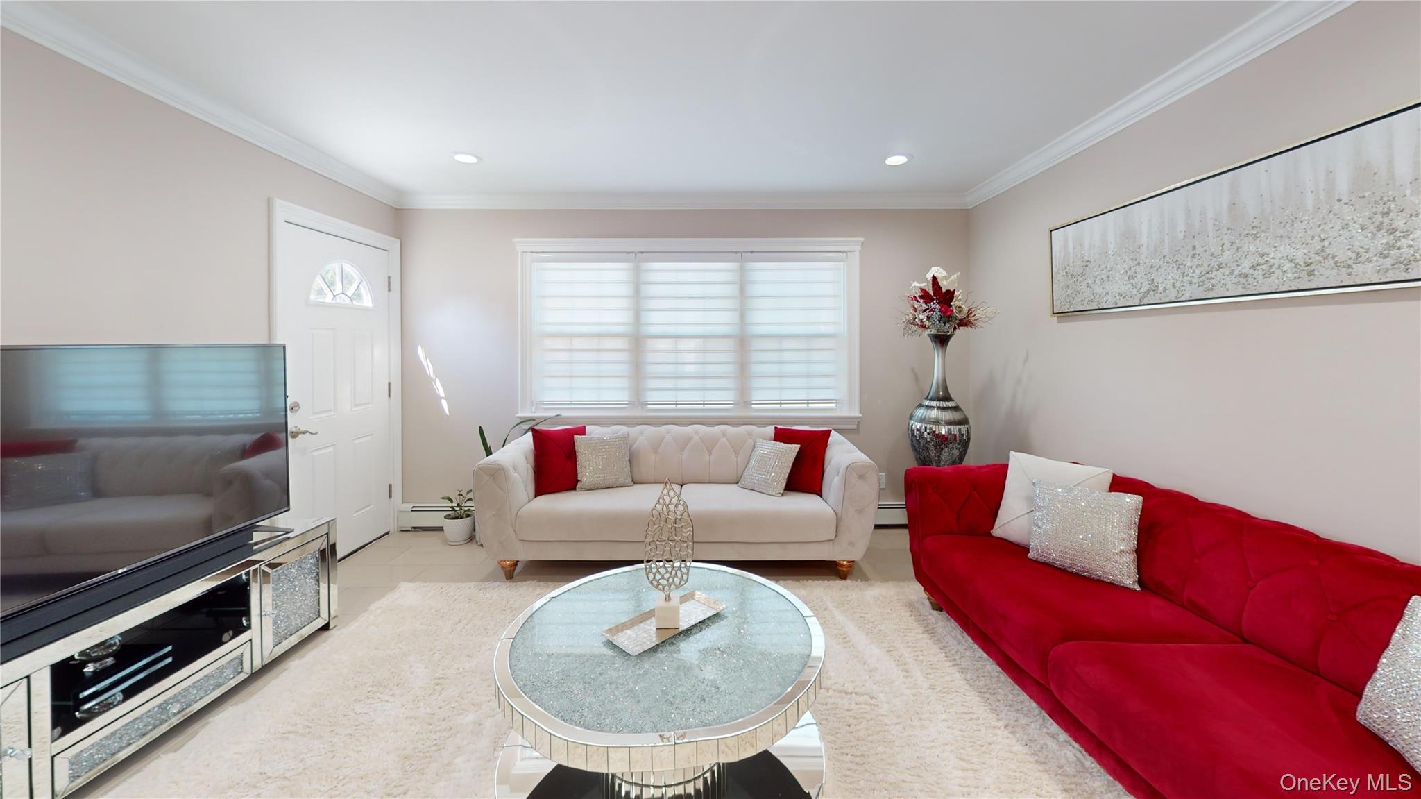 125 Spruce Street Lindenhurst, NY 11757 - Photo 21 of 29 Tiled living room featuring ornamental molding, recessed lighting, and a baseboard radiator