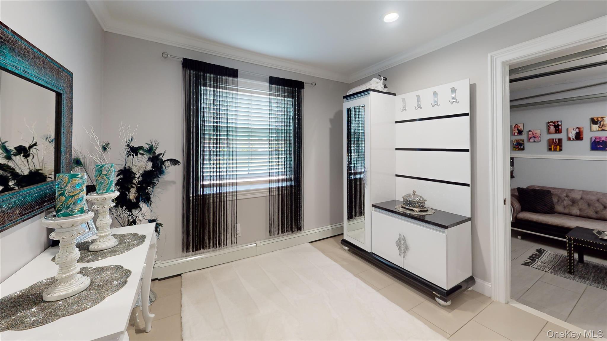 125 Spruce Street Lindenhurst, NY 11757 - Photo 23 of 29 Bathroom with crown molding, vanity, and light tile patterned floors
