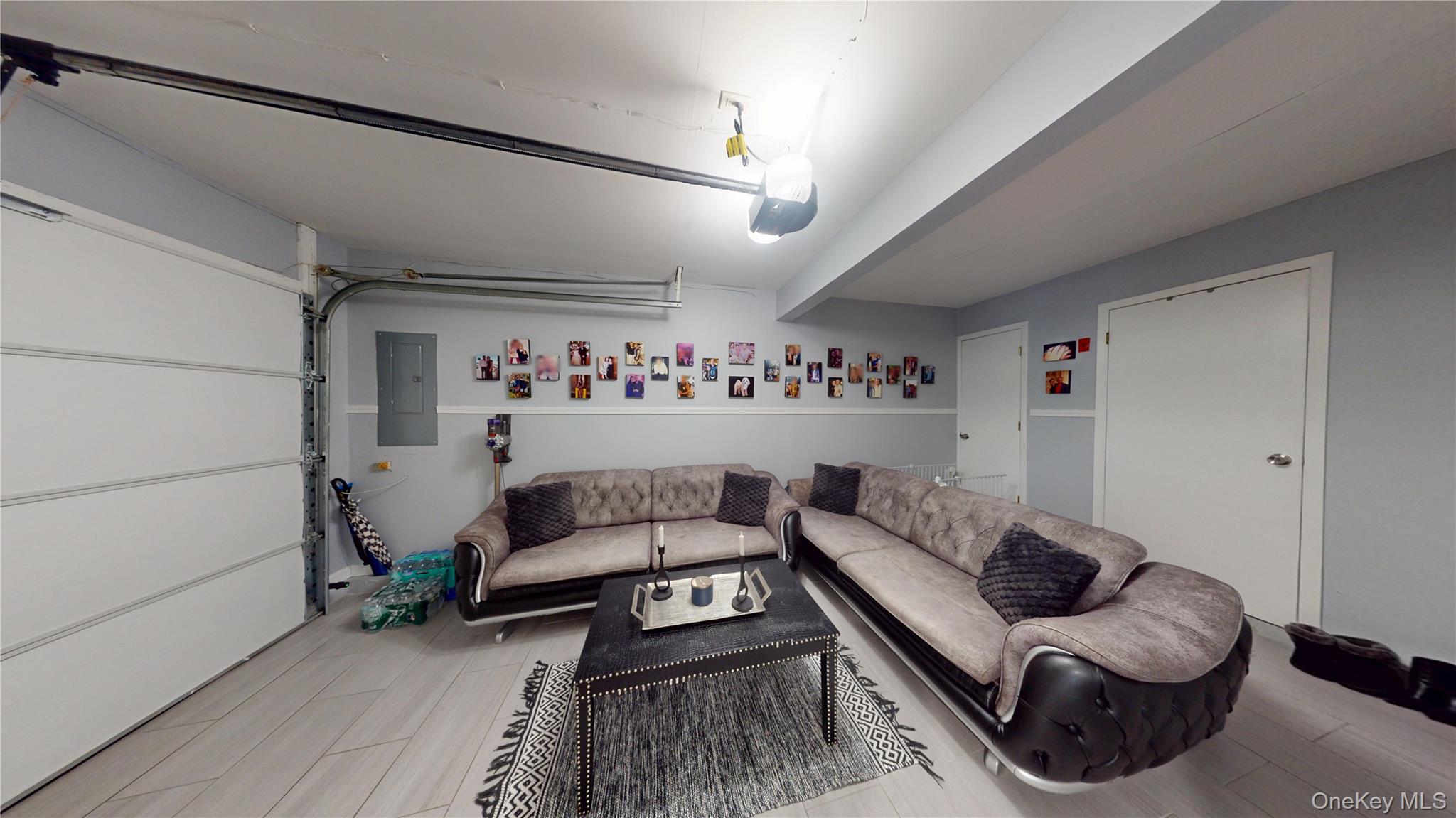 125 Spruce Street Lindenhurst, NY 11757 - Photo 27 of 29 Garage with electric panel and a garage door opener