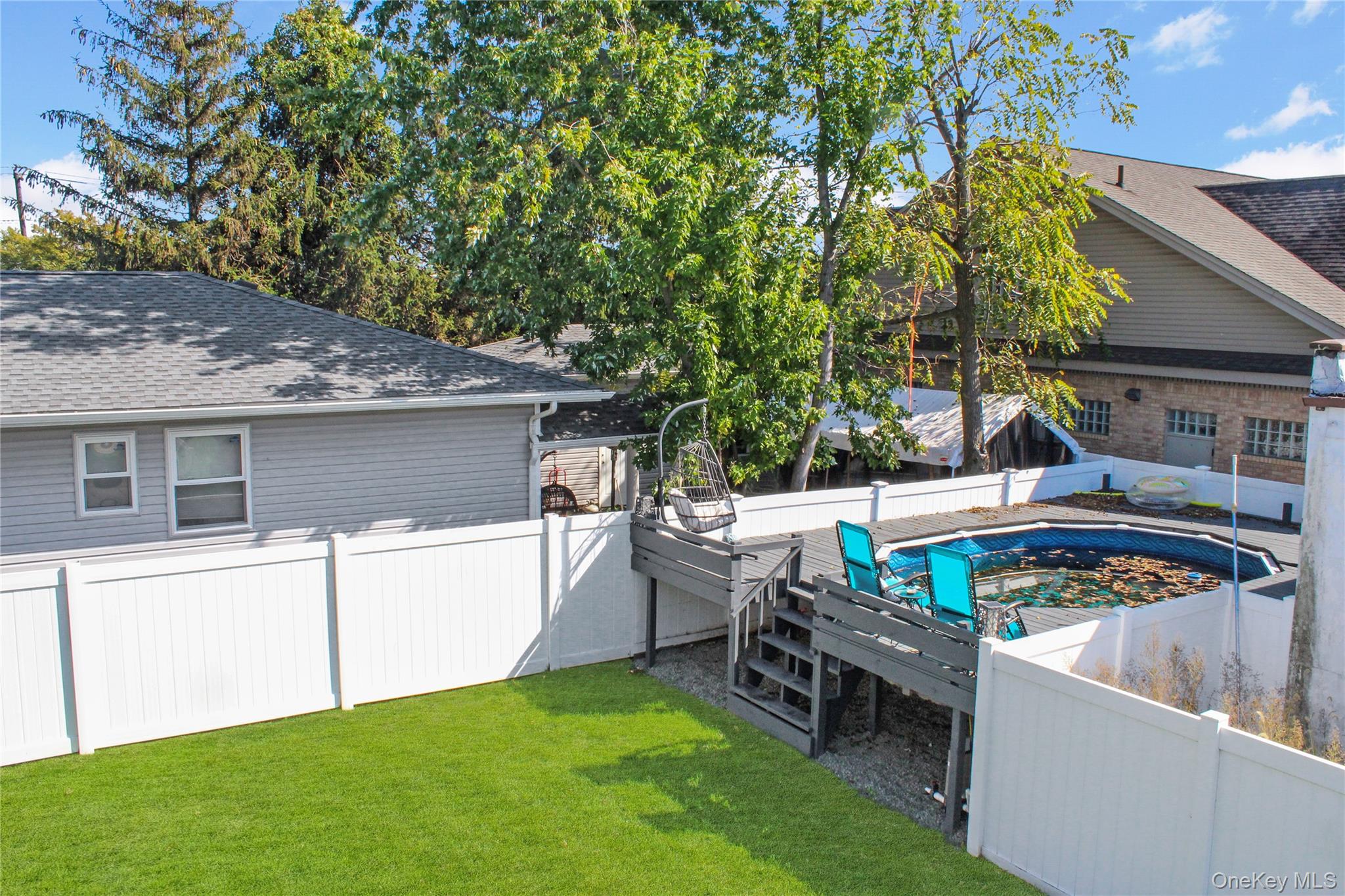 125 Spruce Street Lindenhurst, NY 11757 - Photo 5 of 29 View of pool featuring a fenced backyard and a wooden deck
