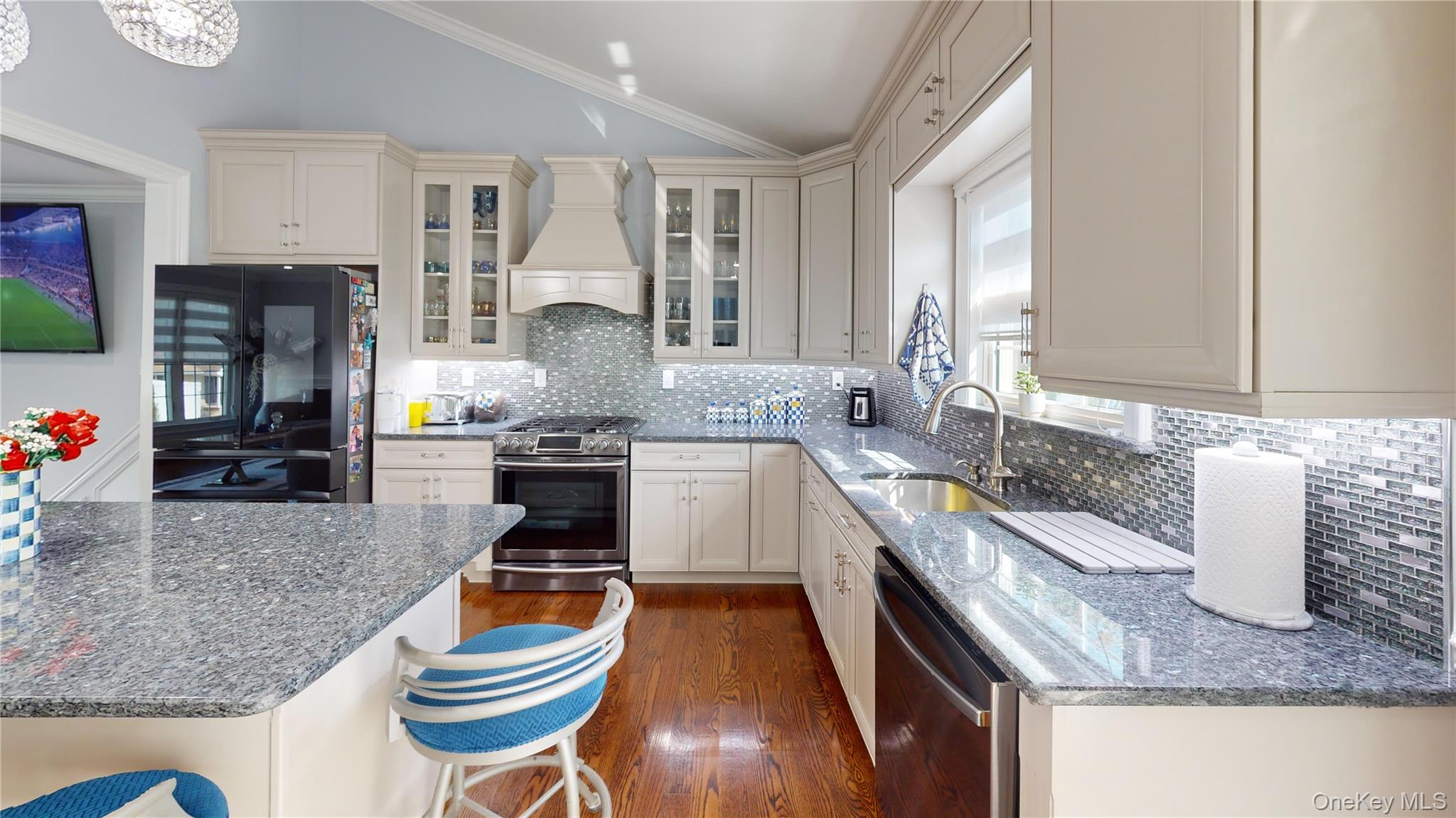 125 Spruce Street Lindenhurst, NY 11757 - Photo 8 of 29 Kitchen featuring dark stone countertops, appliances with stainless steel finishes, decorative backsplash, crown molding, and lofted ceiling