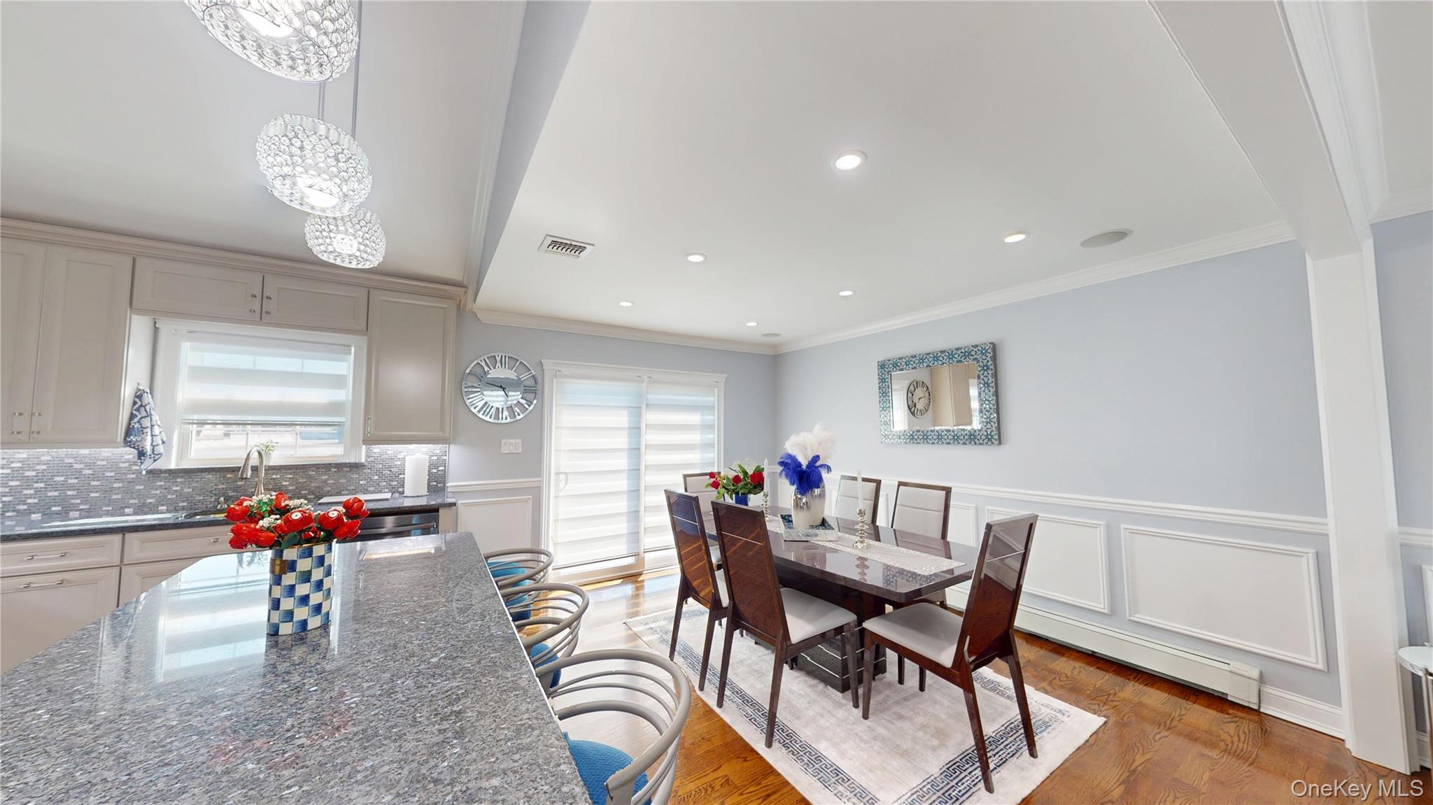 125 Spruce Street Lindenhurst, NY 11757 - Photo 9 of 29 Dining room with crown molding, light wood-type flooring, a decorative wall, recessed lighting, and a wainscoted wall
