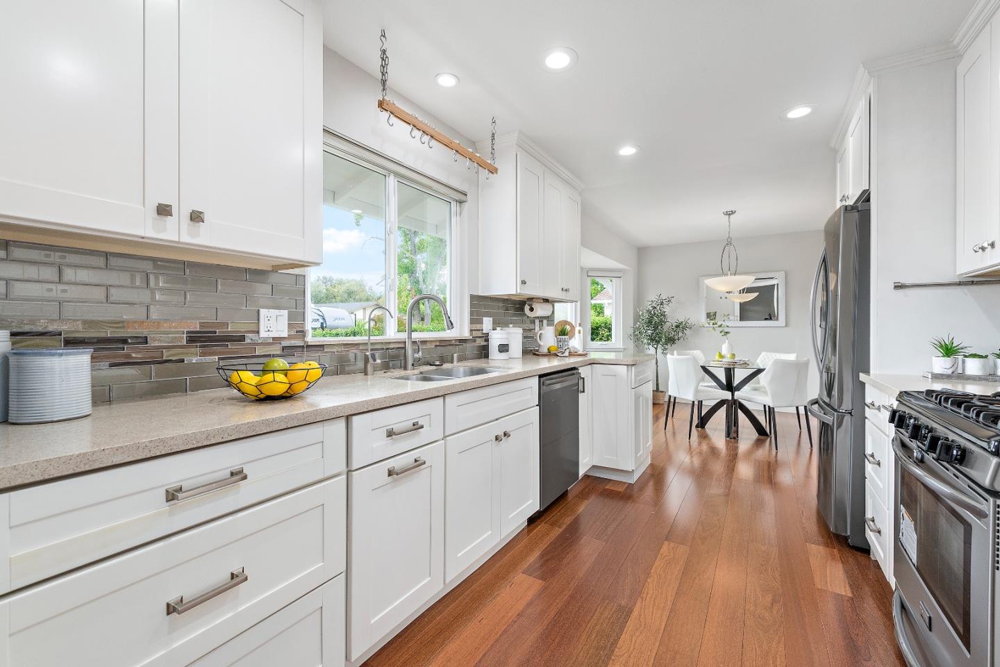 727 Liverpool Way Sunnyvale, CA 94087 - Photo 11 of 26 a kitchen with stainless steel appliances granite countertop a lot of counter space and wooden floors