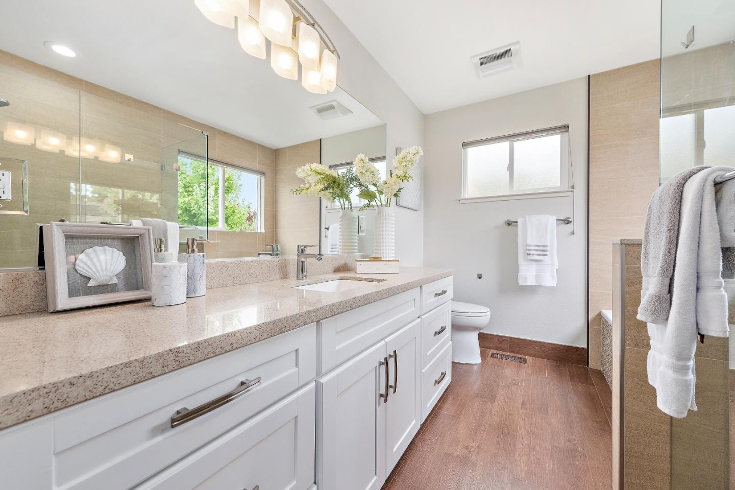 727 Liverpool Way Sunnyvale, CA 94087 - Photo 19 of 26 a spacious bathroom with a granite countertop sink mirror and a shower