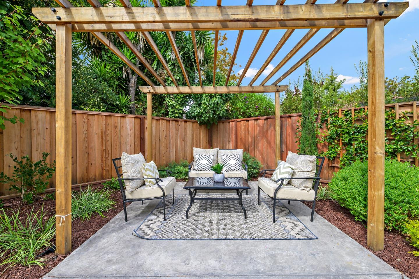 727 Liverpool Way Sunnyvale, CA 94087 - Photo 23 of 26 a view of patio with table and chairs potted plants and large tree