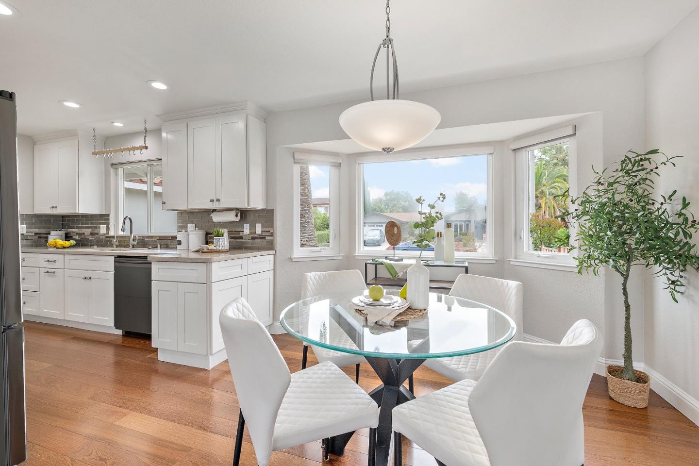 727 Liverpool Way Sunnyvale, CA 94087 - Photo 10 of 26 a kitchen with a dining table chairs and refrigerator