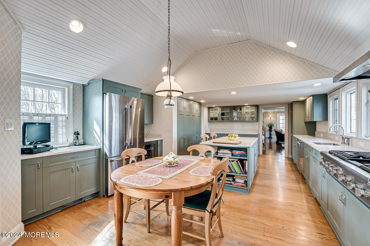 299 County Road 537 Colts Neck, NJ 07722 - Photo 22 of 62 a open kitchen with stainless steel appliances kitchen island a table chairs in it and wooden floors