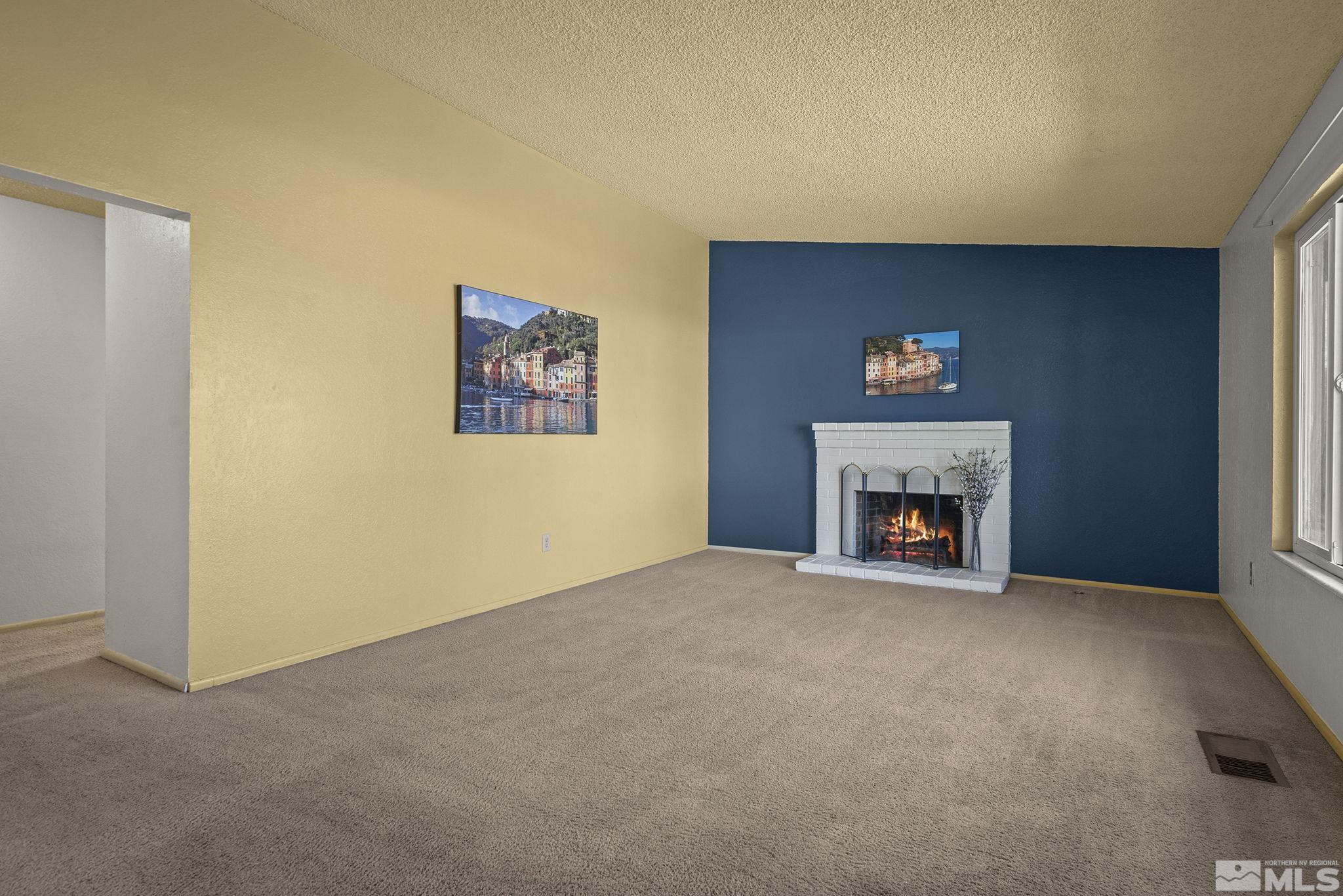 1958 Fieldcrest Drive Sparks, NV 89434 - Photo 3 of 22 a view of an empty room with a fireplace