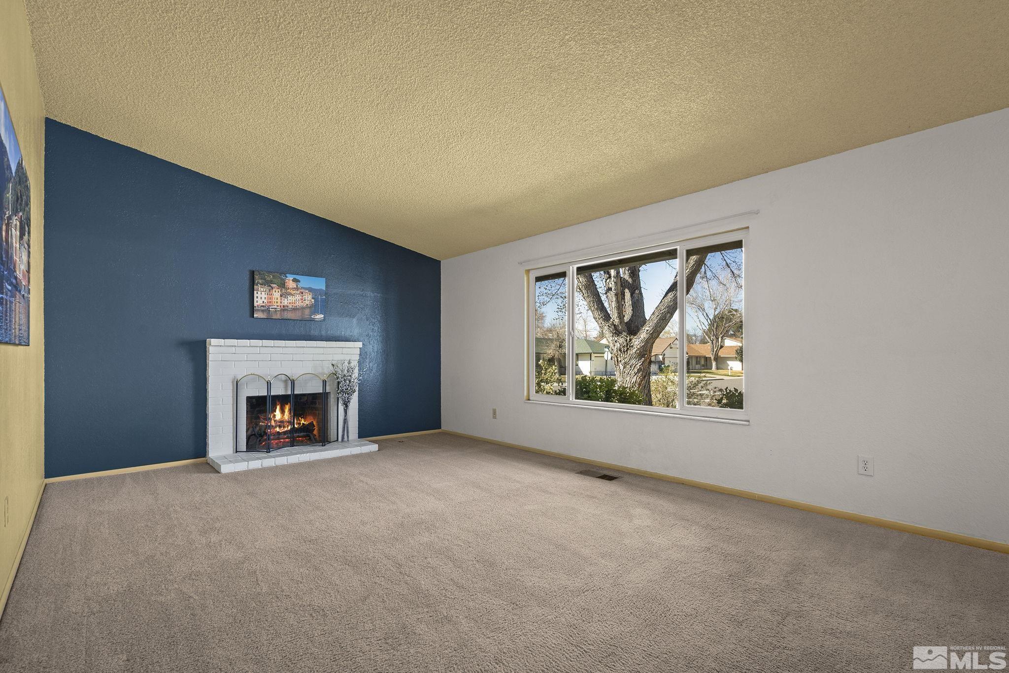 1958 Fieldcrest Drive Sparks, NV 89434 - Photo 4 of 22 an empty room with windows and fireplace