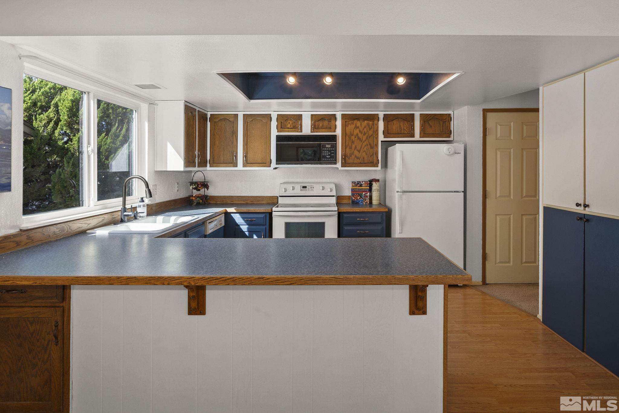1958 Fieldcrest Drive Sparks, NV 89434 - Photo 9 of 22 a kitchen with kitchen island a sink a stove and a refrigerator