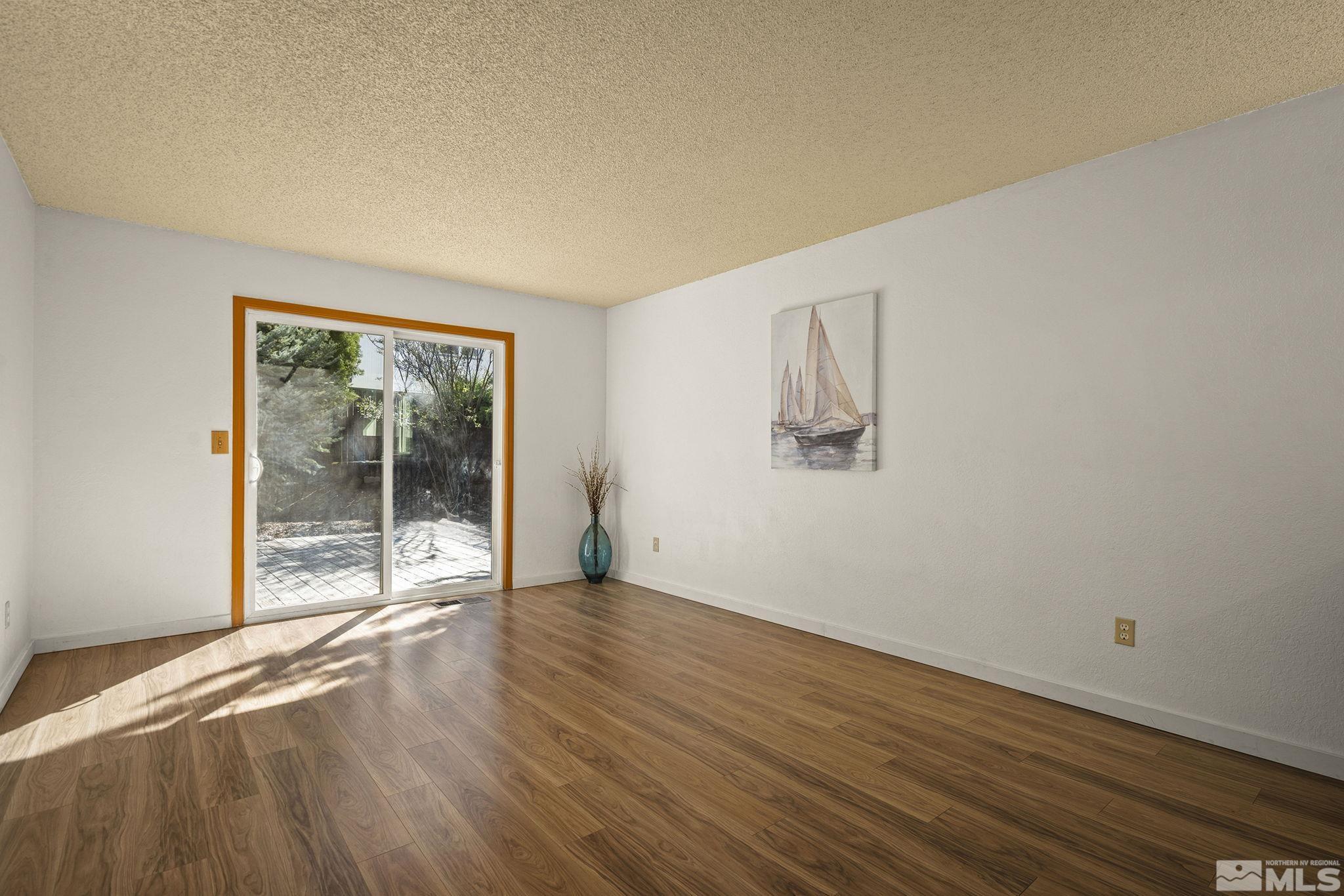 1958 Fieldcrest Drive Sparks, NV 89434 - Photo 10 of 22 a view of an empty room with wooden floor and a window