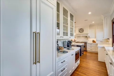 a kitchen with a table chairs sink and cabinets
